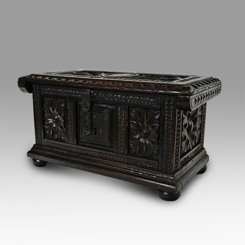 A Spanish Baroque carved walnut money chest